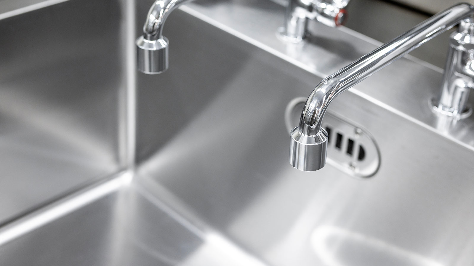 Technician performing scheduled drain maintenance